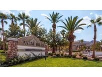 Inviting Palm Hills community entrance with lush landscaping and swaying palm trees offering a warm welcome at 66 John Stuart Mill St, Henderson, NV 89002