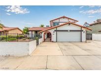 Charming two-story home featuring a well-maintained lawn, driveway, and Spanish style roof at 7384 Valhalla Ln, Las Vegas, NV 89123
