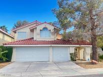 Charming two-story home featuring a two-car garage and tile roof in a quiet neighborhood at 7641 Tortola Bay Ln, Las Vegas, NV 89128