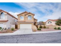 Charming two-story home featuring a tile roof, stucco exterior, desert landscaping, and a two car garage at 7816 Calico Flower Ave, Las Vegas, NV 89128
