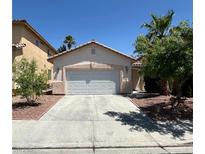 Charming single-story home features a two-car garage, desert landscaping, and a concrete driveway at 8756 Shady Pines Dr, Las Vegas, NV 89143