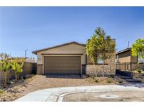 Charming single-story home with a neutral color scheme, brick driveway, and a two car garage at 9351 Aria Ridge Ave, Las Vegas, NV 89143