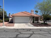 Charming single-story home with a terra cotta tiled roof and a well-maintained two-car garage in a desirable neighborhood at 9600 Pacific View Dr, Las Vegas, NV 89117