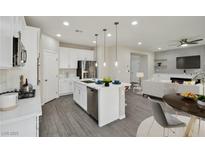 Open-concept kitchen features stainless steel appliances, a large island, and modern finishes at 10270 Turkish Pine Ct, Las Vegas, NV 89166