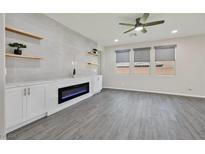 Bright living room featuring a modern fireplace, floating shelves, and neutral tones at 10270 Turkish Pine Ct, Las Vegas, NV 89166