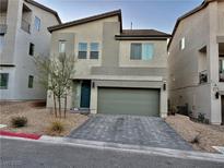 Inviting two-story home with a modern design, featuring a two-car garage and contemporary landscaping at 10411 Rose Palisade St, Las Vegas, NV 89141