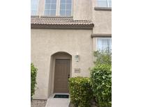 Inviting front entrance featuring a stylish brown door and manicured landscaping at 1512 Couples St, Las Vegas, NV 89128