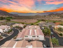 Scenic aerial view of townhouses featuring red tiled roofs, mountain and lake views at 251 Big Horn Dr, Boulder City, NV 89005