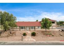 Charming single story home featuring desert landscaping, covered entry, and large windows at 301 E Longacres Dr, Henderson, NV 89015