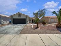 Charming single-story home featuring desert landscaping, a two-car garage, and a welcoming facade at 3109 W Colton Ave, North Las Vegas, NV 89032