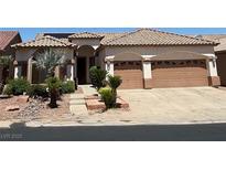 Charming single-story home featuring a two-car garage, desert landscaping, and a tile roof at 379 Marlin Cove Rd, Henderson, NV 89012