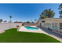 Backyard view showcasing the private pool and lush artificial turf, perfect for outdoor enjoyment at 3986 Belleville Ave, Las Vegas, NV 89121