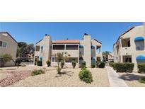 Charming two-story condo with adobe-style facade, awnings, and landscaped front yard at 4941 Newport Cove Dr # B, Las Vegas, NV 89119