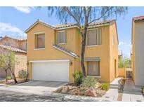 Two-story home with a two-car garage, desert landscaping, and a tile roof at 5674 Moccasin Point St, Las Vegas, NV 89148
