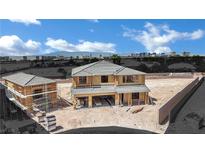 New construction home showing wood framing and a detached garage in a desert setting with city views at 7118 Painted Skyline St, Las Vegas, NV 89118