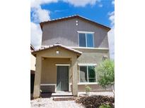 Charming two-story home with a covered porch and neutral stucco exterior under a partly cloudy sky at 7411 Sunray Point St, North Las Vegas, NV 89084