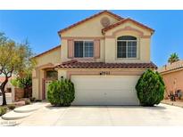 Charming two-story home with a red tile roof, a two-car garage, and well-maintained landscaping at 7521 Reindeer Ct, Las Vegas, NV 89147