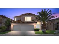 Charming two-story home boasts a three car garage, red tile roof, and lush landscaping at 8083 Shadowvale Dr, Las Vegas, NV 89147