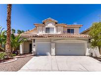 Charming two-story home featuring a red tile roof and a spacious three-car garage at 9500 Catalina Cove Cir, Las Vegas, NV 89147