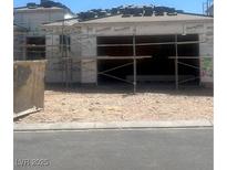 Unfinished home with two-car garage being built and scaffolding at 10266 Rosemont Hills St, Las Vegas, NV 89141