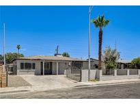Charming single-story home with a desert landscape, block wall, and gated entrance at 1641 K St, Las Vegas, NV 89106