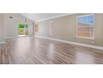 Bright living room showcasing sleek floors, multiple windows, and a sliding glass door at 1804 Michael Ct, Henderson, NV 89014