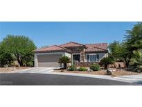 Charming single-story home with a two-car garage, desert landscaping, and a tile roof at 2188 Cumberland Hill Dr, Henderson, NV 89052