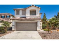 Two story home features a desert landscape, tile roof, and a two car garage at 3141 Diamond Crest Ln, Henderson, NV 89052