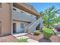 Two story condo with stucco exterior, stairway to upper units and desert landscaping at 3151 Soaring Gulls Dr # 2050, Las Vegas, NV 89128