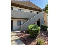 Charming two-story condo with well-maintained landscaping and gray stucco accents at 3151 Soaring Gulls Dr # 2050, Las Vegas, NV 89128