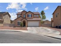 Charming two-story home features a desert landscape, attached garage, and neutral color palette at 5228 Giallo Vista Ct, North Las Vegas, NV 89031