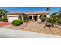 Charming single-story home with desert landscaping and a brick walkway leading to the front door at 561 Carmel Valley St, Henderson, NV 89012