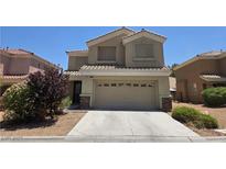 Inviting two-story home featuring a well-manicured yard and neutral color palette at 6638 Babys Tear Pl, Las Vegas, NV 89148