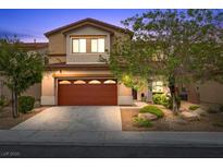 Inviting two-story home featuring a well-maintained yard and a two-car garage, perfect for a Gathering at 7028 Weavers Pl, North Las Vegas, NV 89084