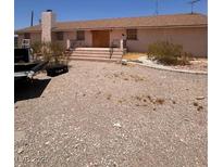Ranch-style home with a front entrance accessed by exterior stairs at 7052 W Meranto Ave, Las Vegas, NV 89178