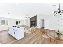 Bright open-concept living space with a fireplace feature wall and modern decor at 811 Spyglass Ln, Las Vegas, NV 89107