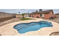 Inviting backyard pool with tanning deck, perfect for relaxation and outdoor entertainment at 1004 Woodside Ct, Henderson, NV 89015