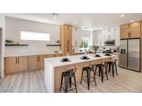 Modern kitchen featuring a large island with seating and stainless steel appliances at 2561 Terrytown Ave, Henderson, NV 89052