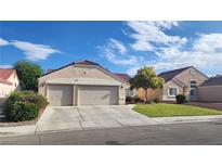 Charming single-story home featuring a well-manicured lawn and a two-car garage at 2707 Gardenia Flower Ave, North Las Vegas, NV 89031