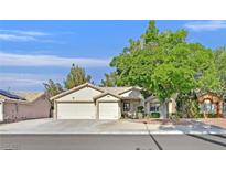 Charming single-story home with a two-car garage and a mature tree in the front yard at 4624 Windy Hollow St, Las Vegas, NV 89130
