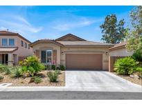 Charming single-story home with desert landscaping, a two-car garage and a tile roof at 4937 Graziano Ave, Las Vegas, NV 89141