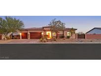 Beautiful single-story home with a well-manicured yard and a spacious three-car garage at 5801 Exbury Gardens Ct, Las Vegas, NV 89118