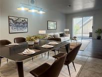 Modern dining room with a black dining table set for six and a view into the living area at 6250 W Flamingo Rd # 88, Las Vegas, NV 89103