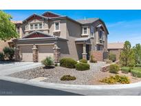 Charming two-story home featuring a two car garage and a beautifully landscaped front yard at 7814 Granite City Ct, Las Vegas, NV 89166
