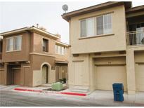 Two-story townhomes with neutral stucco exteriors and attached garages at 10231 Delray Beach Ave # 201, Las Vegas, NV 89129