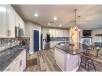 Modern kitchen features stainless steel appliances, granite countertops, stylish backsplash, and a large kitchen island at 10243 Aragon Crown Rd, Las Vegas, NV 89135