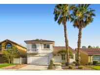 Charming two-story home with a well-maintained yard and Spanish tile roof, complemented by mature palm trees at 1547 Balsam Mist Ave, Las Vegas, NV 89183
