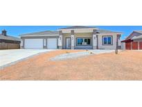 Charming single-story home featuring desert landscaping, a two-car garage, and a modern architectural design at 2150 S Manzanita Dr, Pahrump, NV 89048