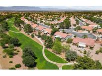 Beautiful aerial view of community homes on a golf course with distant mountain views at 2509 Big Timber Dr, Las Vegas, NV 89134