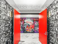 Bright, modern condo entrance with vibrant Las Vegas themed decor and red doors at 2777 Paradise Rd # 2801, Las Vegas, NV 89109